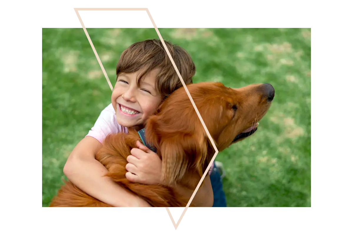 Happy boy cuddling a dog
