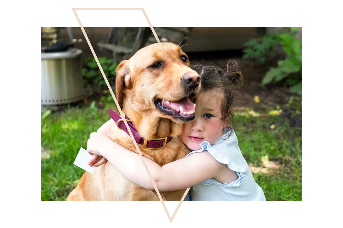 Happy boy cuddling a dog